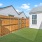A fenced in yard with grass