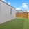 A fenced in yard with grass